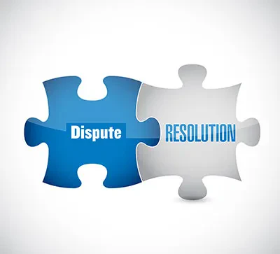 Two puzzle pieces interlocking together, with the blue piece labeled Dispute in white and the grey piece labeled RESOLUTION in blue.